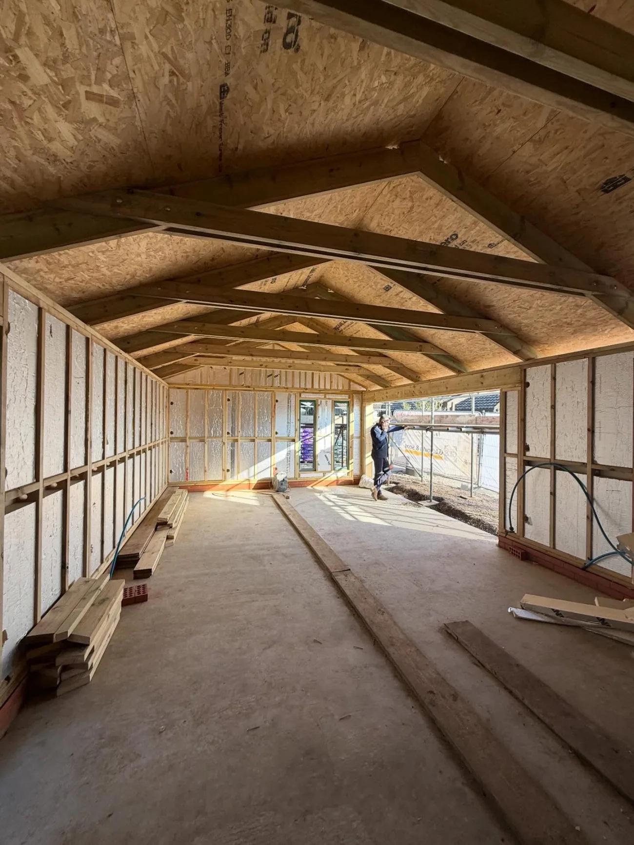 A new room framed out, its timber roof structure exposed before lining