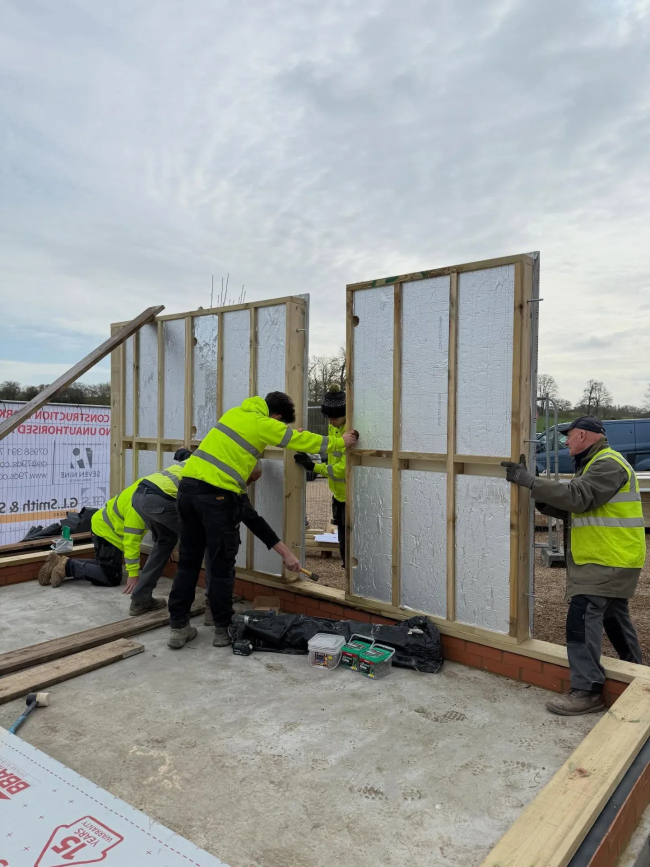 The team raising an insulated timber-frame wall on a new build