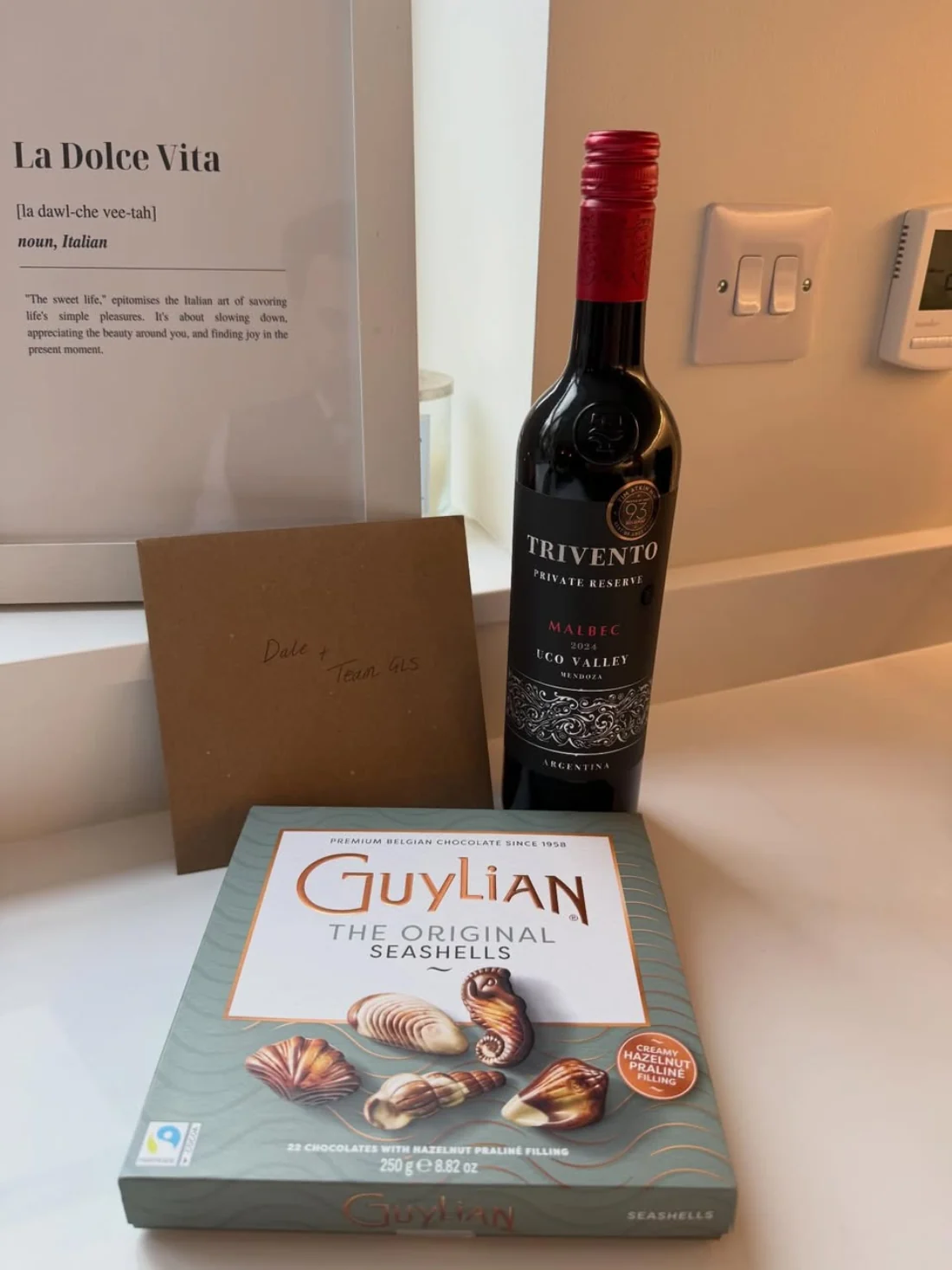 A thank-you gift to Dale and the GLS team: wine, Belgian chocolates and a La Dolce Vita print